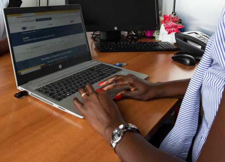  Female hands typing on a laptop keyboard. 